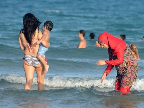 A woman wears a burkini on a beach in Tunisia. Photograph: Fethi Belaid/AFP/Getty Images