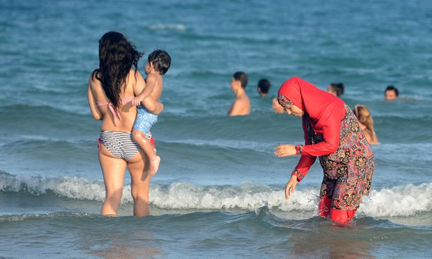 A woman wears a burkini on a beach in Tunisia. Photograph: Fethi Belaid/AFP/Getty Images